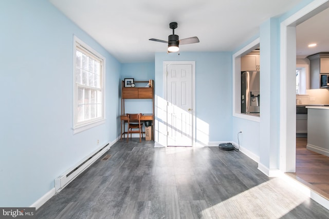 interior space with ceiling fan, baseboards, baseboard heating, and dark wood-type flooring