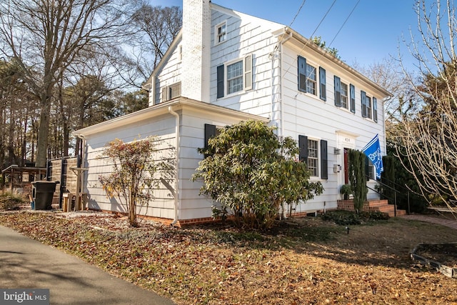 view of side of home with a chimney