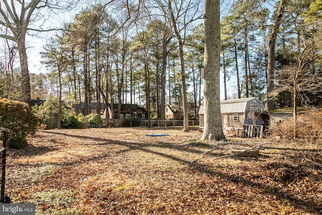 view of yard featuring an outbuilding and fence