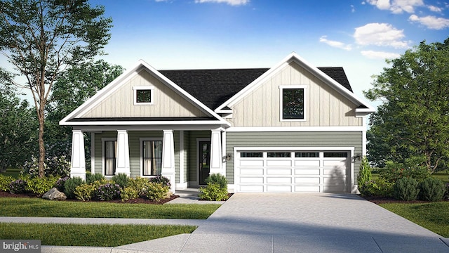 view of front of property featuring covered porch, a garage, and a front yard