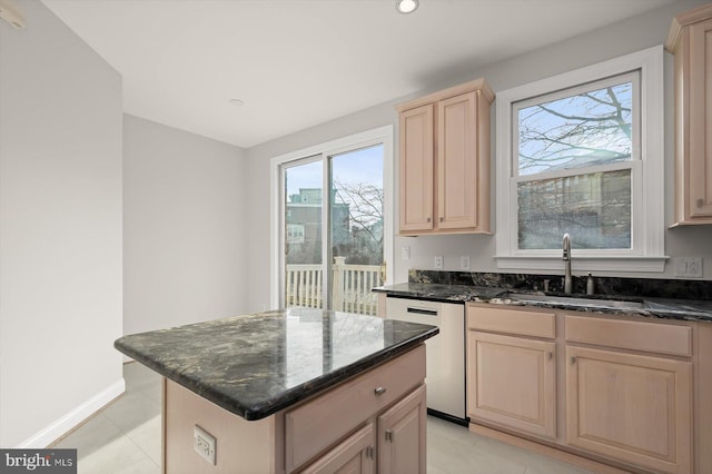 kitchen with dishwasher, a healthy amount of sunlight, a kitchen island, and sink