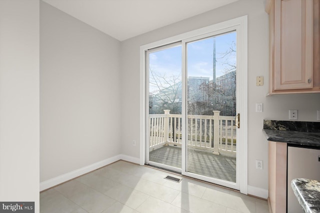 doorway with light tile patterned flooring