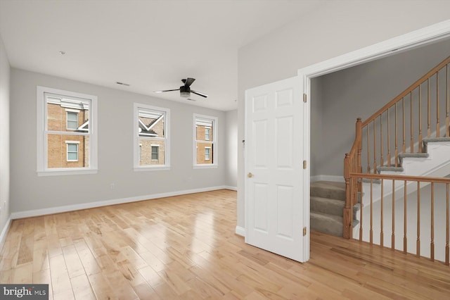 empty room with light wood-type flooring and ceiling fan