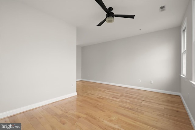 empty room with light wood-type flooring and ceiling fan