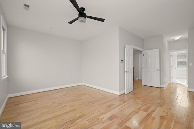 empty room featuring ceiling fan and light wood-type flooring