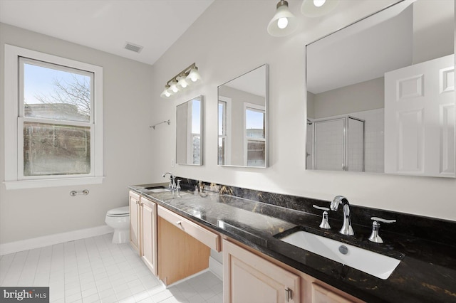 bathroom featuring tile patterned flooring, vanity, an enclosed shower, and toilet