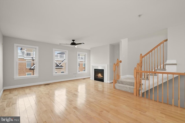 unfurnished living room with ceiling fan, plenty of natural light, and light hardwood / wood-style floors