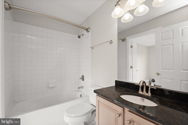 full bathroom featuring vanity, toilet, and tiled shower / bath combo