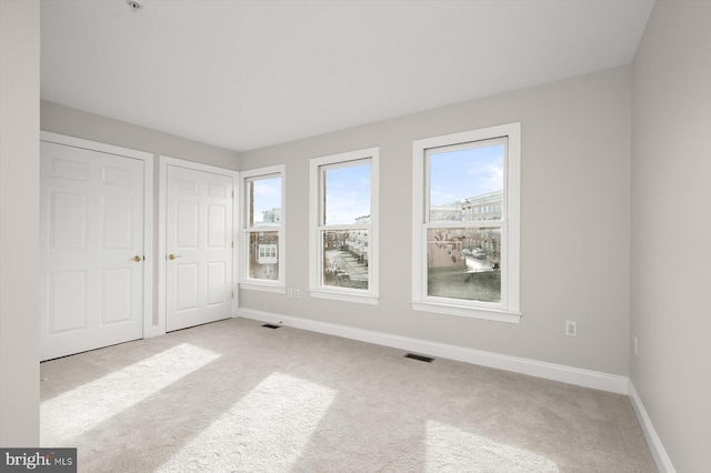 spare room with light colored carpet