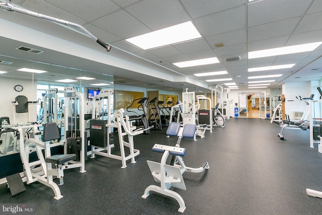 exercise room featuring a paneled ceiling