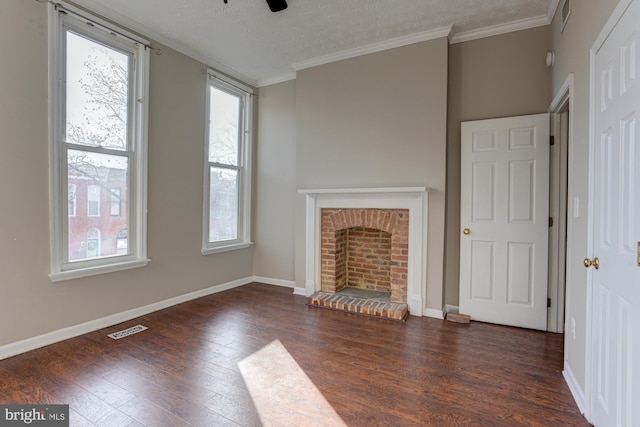 unfurnished living room with a textured ceiling, ceiling fan, crown molding, a fireplace, and dark hardwood / wood-style floors