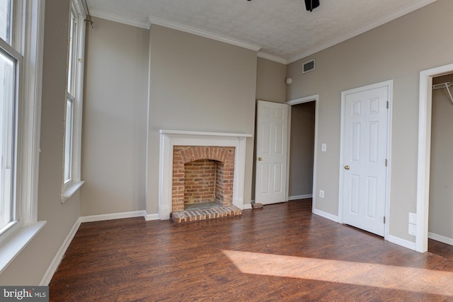 unfurnished living room with crown molding, a fireplace, dark hardwood / wood-style floors, and a textured ceiling