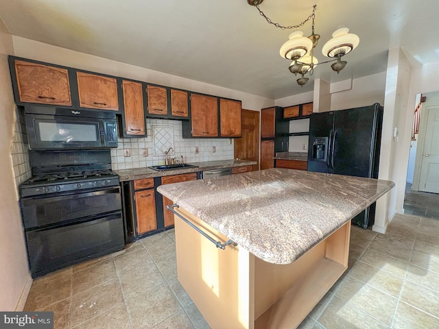 kitchen with sink, tasteful backsplash, a notable chandelier, a kitchen island, and black appliances