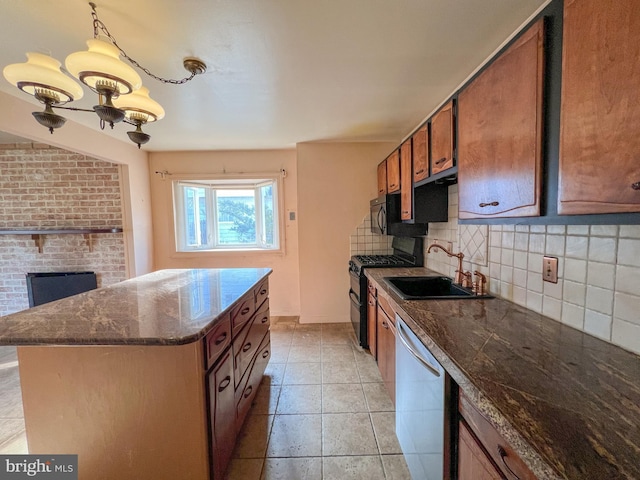 kitchen featuring a center island, backsplash, an inviting chandelier, sink, and appliances with stainless steel finishes