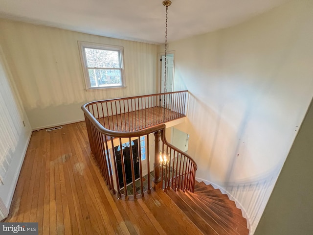 stairs featuring hardwood / wood-style floors