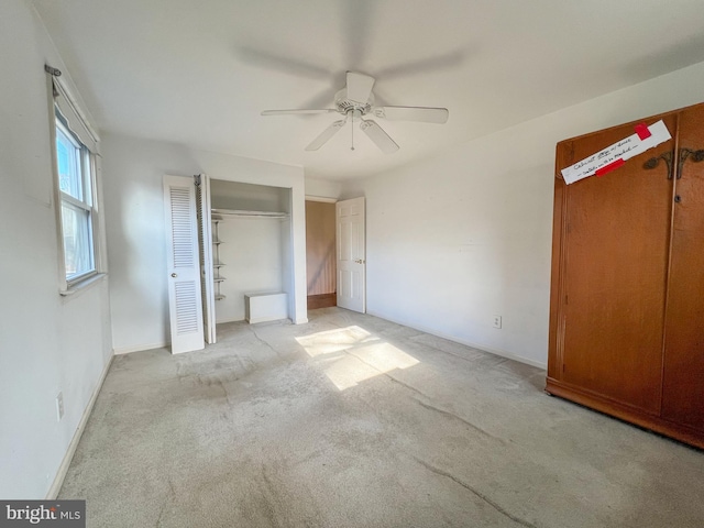 unfurnished bedroom with ceiling fan and light carpet