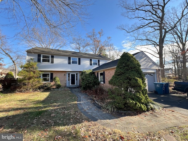 view of front facade with a front yard and a garage