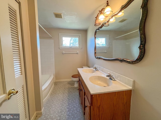 full bathroom featuring tile patterned floors, vanity, toilet, and tiled shower / bath combo