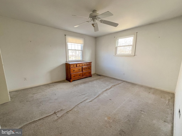 carpeted spare room with ceiling fan