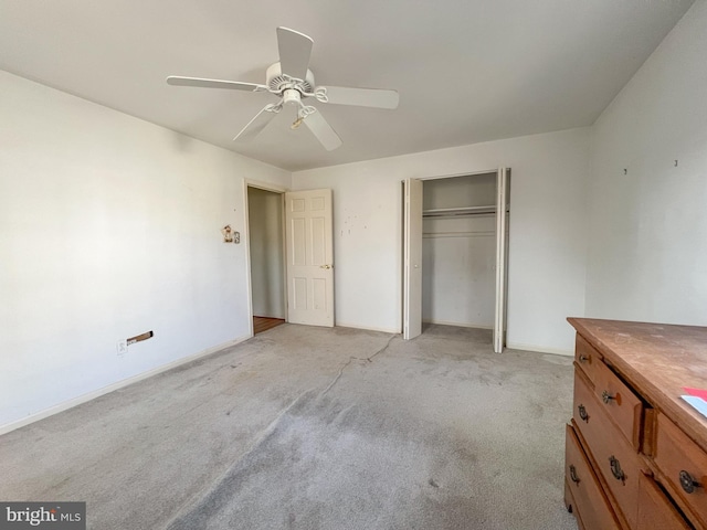 unfurnished bedroom featuring a closet, ceiling fan, and light colored carpet