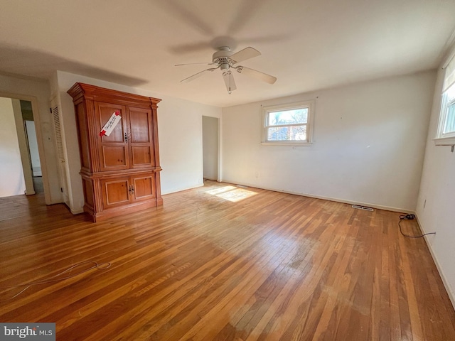 empty room featuring hardwood / wood-style flooring and ceiling fan