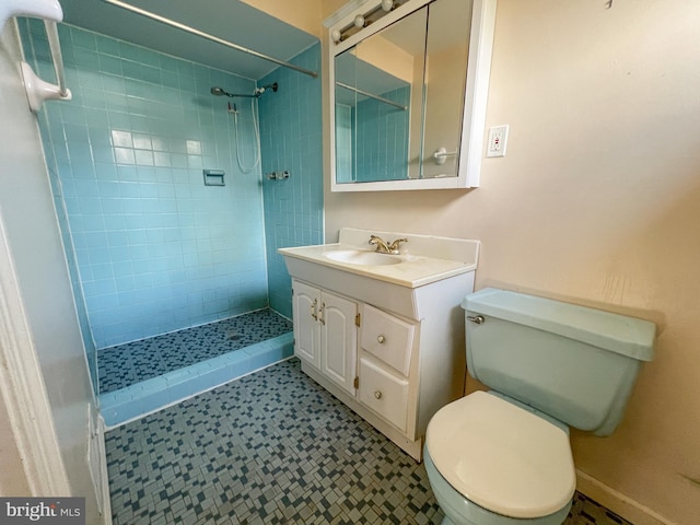 bathroom featuring tiled shower, vanity, and toilet