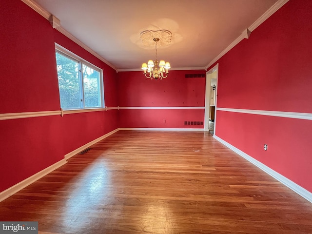 unfurnished dining area featuring a chandelier, wood-type flooring, and crown molding