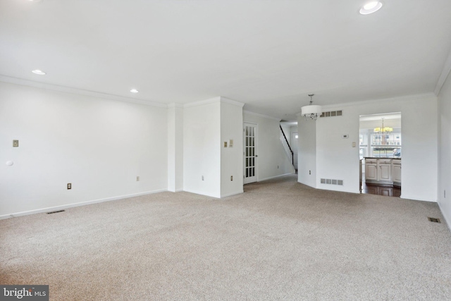 unfurnished living room with carpet, a chandelier, and crown molding