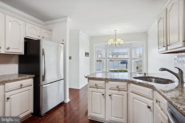 kitchen featuring white cabinetry, sink, dark wood-type flooring, decorative backsplash, and appliances with stainless steel finishes