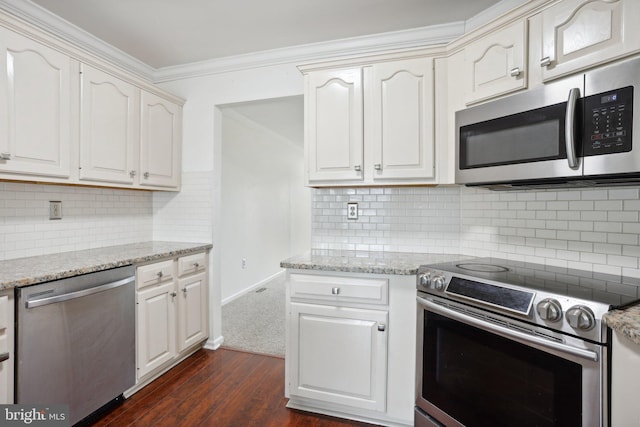 kitchen with backsplash, stainless steel appliances, white cabinetry, and dark hardwood / wood-style floors