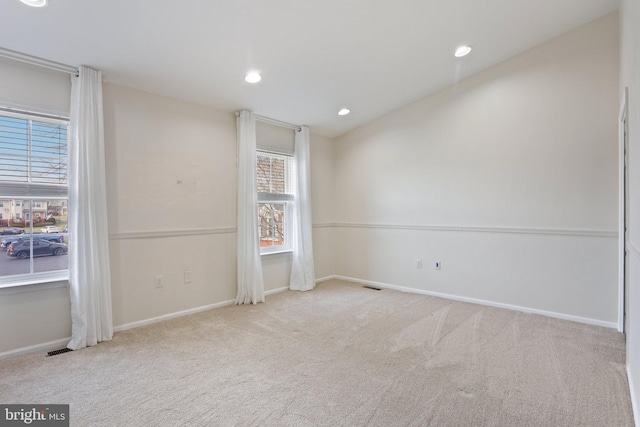 carpeted empty room featuring vaulted ceiling