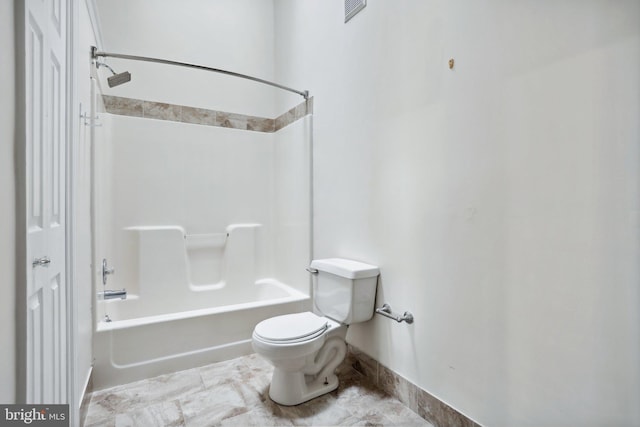 bathroom featuring shower / bath combination and toilet