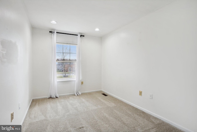 empty room with light colored carpet