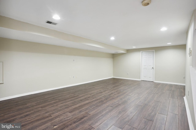 basement with dark hardwood / wood-style floors