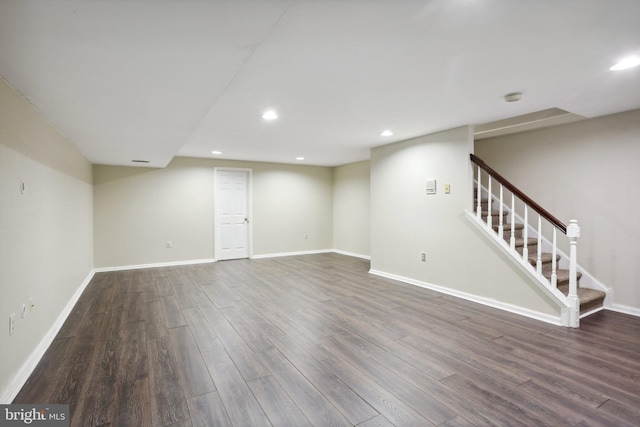 basement with dark hardwood / wood-style flooring