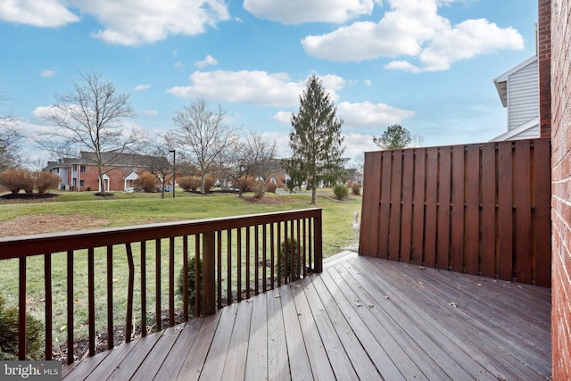 wooden terrace featuring a yard