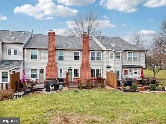 back of house featuring a deck and a yard