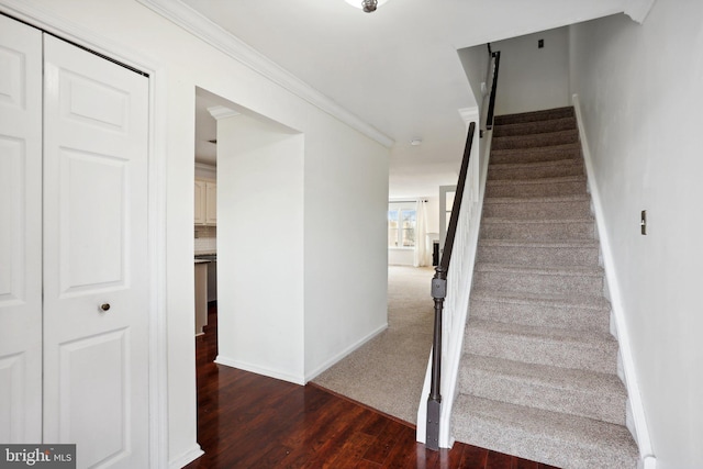 staircase with ornamental molding and hardwood / wood-style flooring