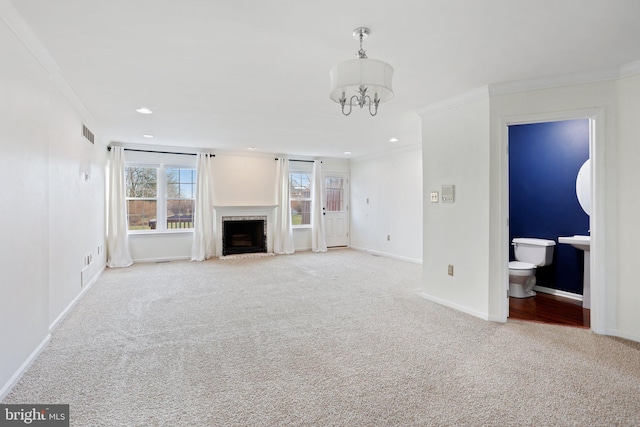 unfurnished living room with light carpet, crown molding, and an inviting chandelier