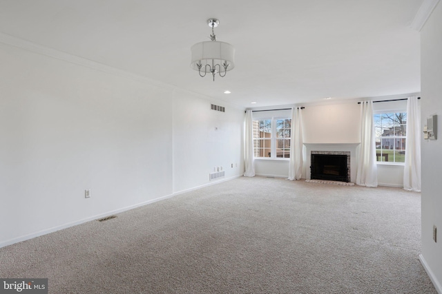 unfurnished living room with a fireplace, ornamental molding, and light carpet