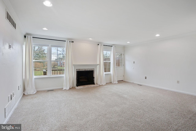 unfurnished living room with a fireplace, light colored carpet, and ornamental molding