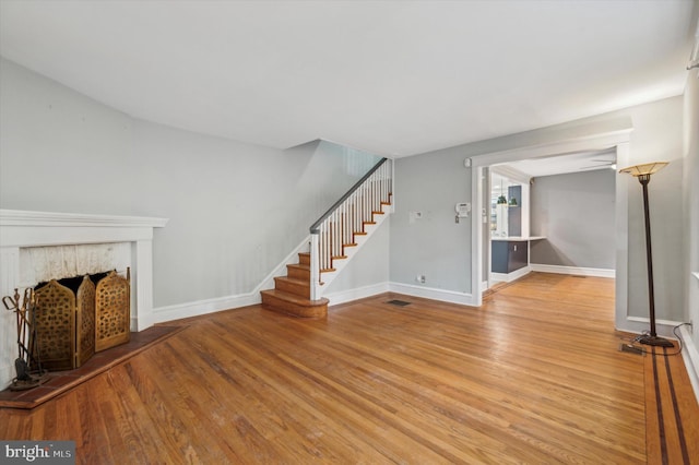 unfurnished living room with a fireplace and light hardwood / wood-style floors