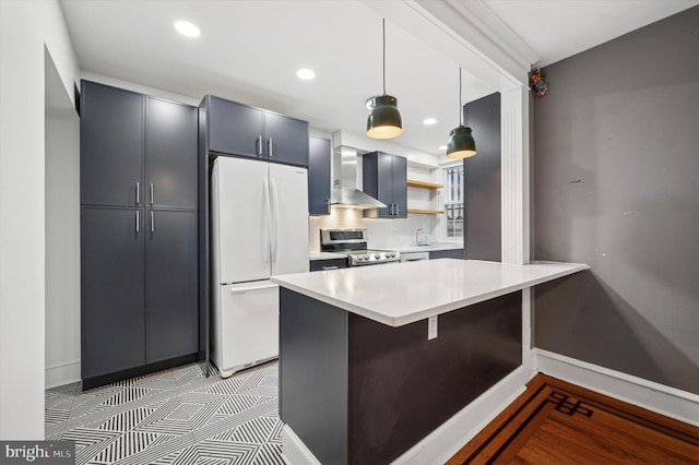 kitchen featuring a breakfast bar, white refrigerator, wall chimney range hood, hanging light fixtures, and electric range