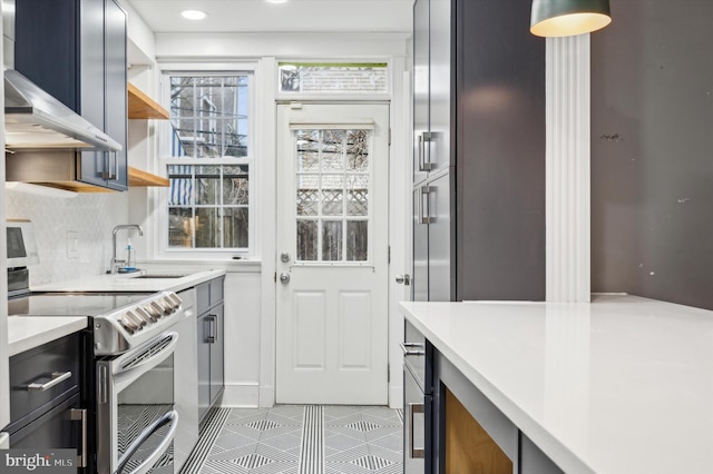 kitchen featuring sink, wall chimney exhaust hood, backsplash, electric stove, and light tile patterned floors