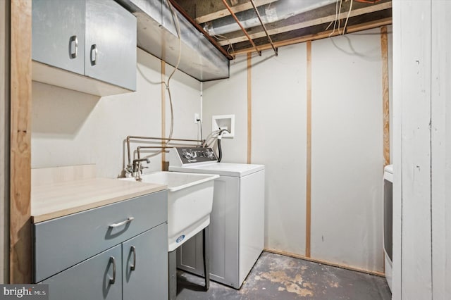 laundry room with washer and clothes dryer and cabinets