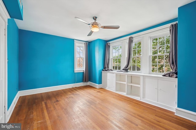 spare room with ceiling fan and wood-type flooring