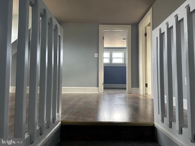 hallway with hardwood / wood-style floors