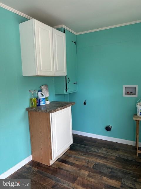 kitchen with dark hardwood / wood-style floors, white cabinetry, and ornamental molding