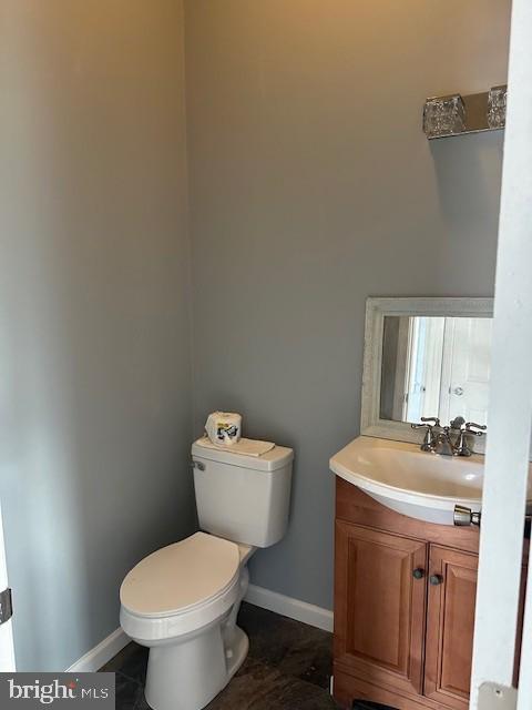 bathroom featuring tile patterned flooring, vanity, and toilet