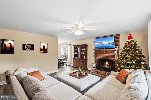 living room featuring a fireplace, hardwood / wood-style flooring, and ceiling fan